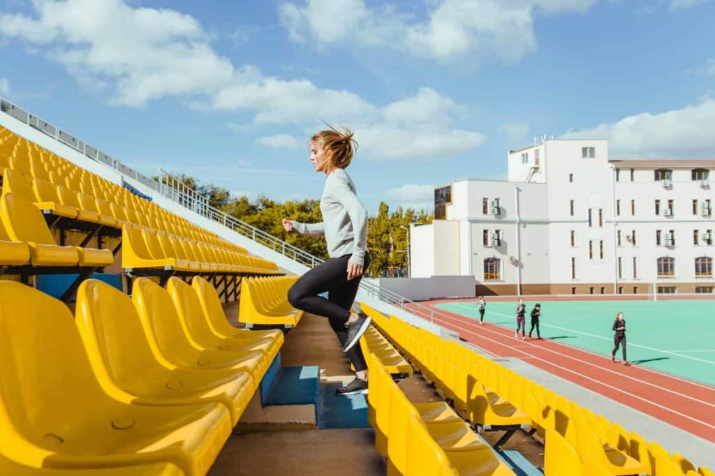 Sports woman running at stadium