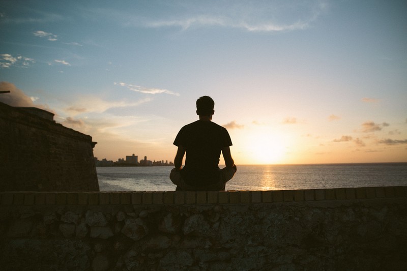 Man looking at the sun rising