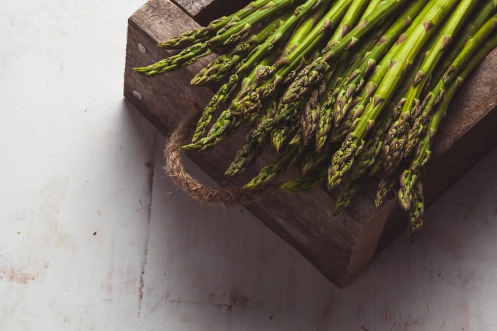 Asparagus on a cutting board. Healthy food, health on a concrete background